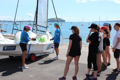 Segeln in der "City of Sails" Einer Gruppe von Studenten wird im Hafen das Trainings-Segelboot erklärt