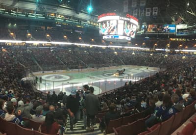 Beeindruckende Atmosphäre Gut gefülltes Eishockey-Stadion mit leuchtender Anzeigetafel im Zentrum.