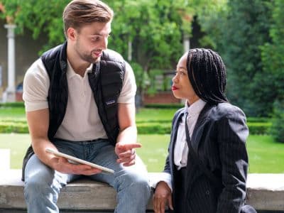 An der Cattolica lernst du schnell Gleichgesinnte kennen. Studierende im Gespräch miteinander.